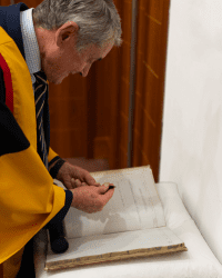 Sir Harry Burns signs our Honorary Fellowship book